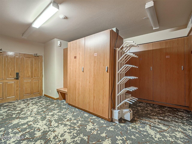 interior space featuring carpet and baseboards