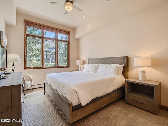 bedroom featuring light carpet and a ceiling fan