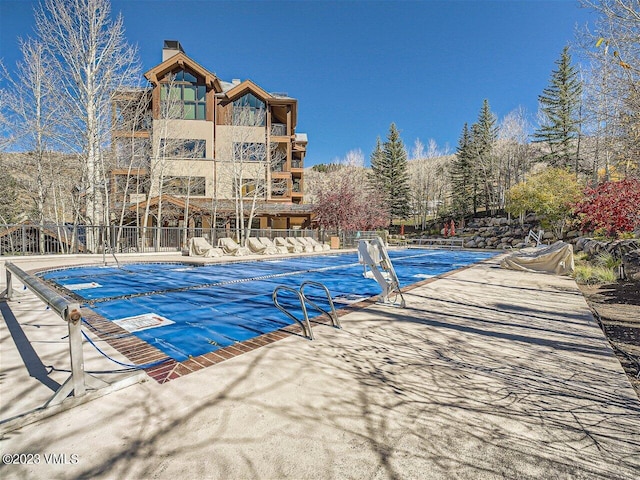 pool featuring a patio and fence