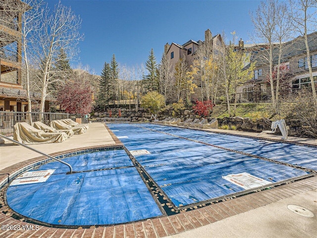 view of pool featuring fence