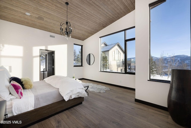 bedroom with an inviting chandelier, wood-type flooring, a mountain view, vaulted ceiling, and wooden ceiling