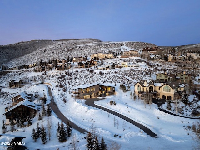 snowy aerial view with a mountain view