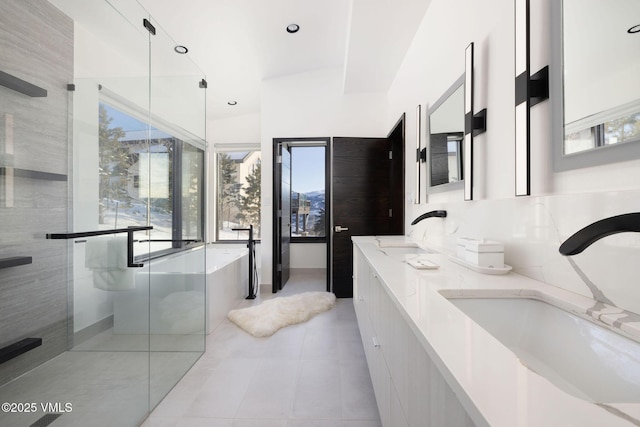 bathroom with tile patterned floors, vanity, and a shower with shower door