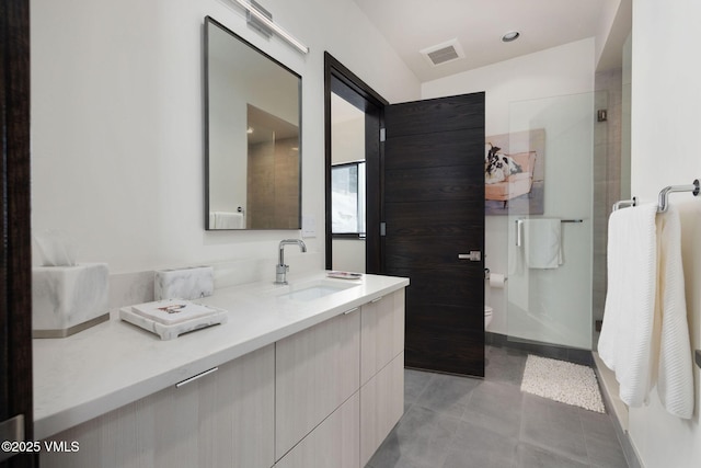 bathroom featuring walk in shower, tile patterned floors, vanity, and toilet