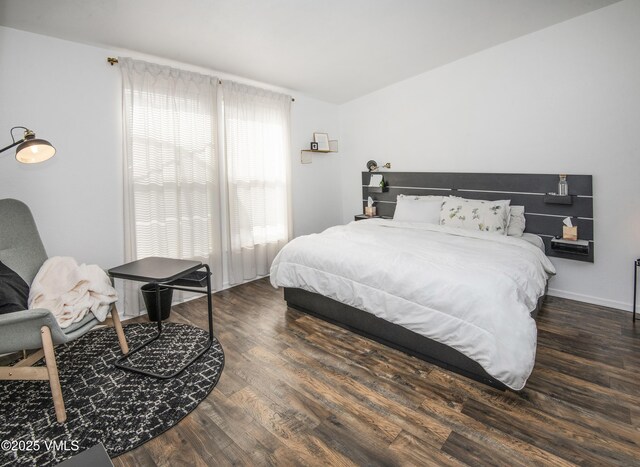 bedroom featuring vaulted ceiling and dark hardwood / wood-style flooring