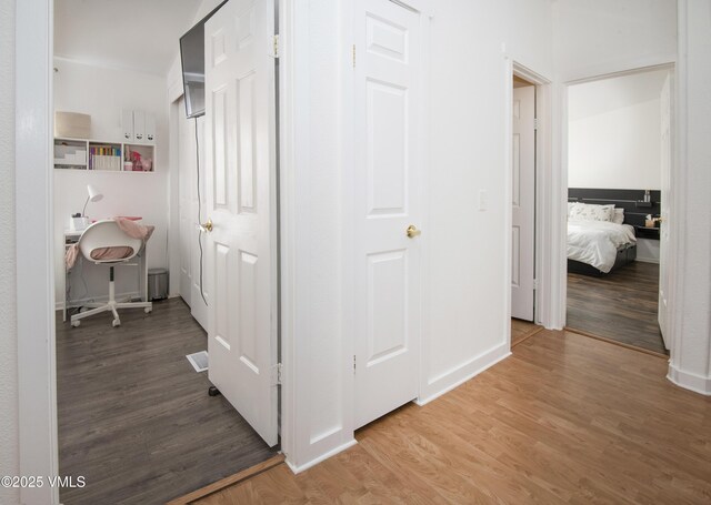 corridor with wood-type flooring