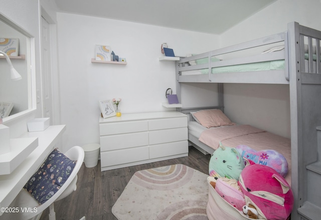 bedroom with dark wood-type flooring