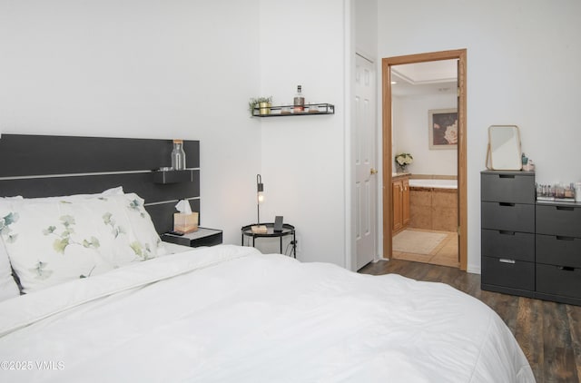 bedroom featuring dark wood-type flooring and connected bathroom