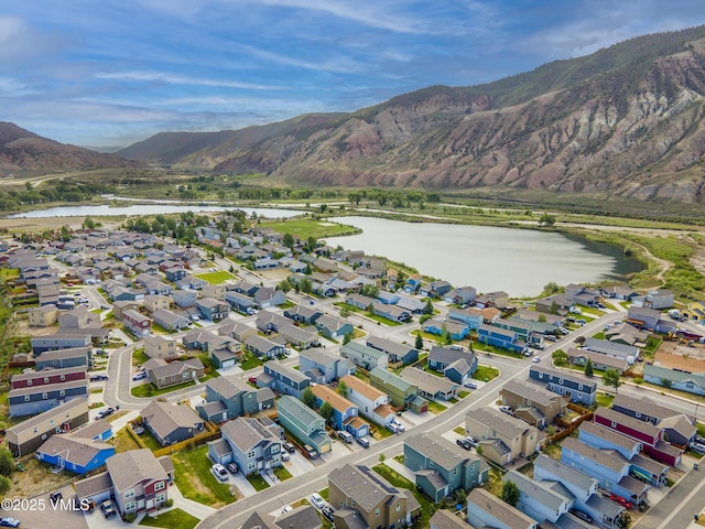 birds eye view of property with a water and mountain view