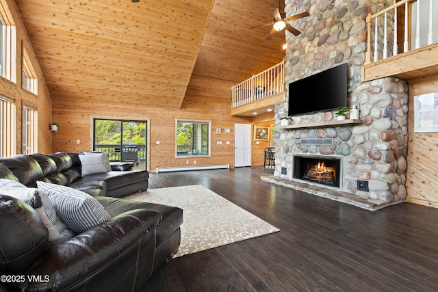 2980 Salt Creek Rd, Eagle, CO 81631 - living area featuring high vaulted ceiling, a ceiling fan, wooden walls, a stone fireplace, and a baseboard radiator