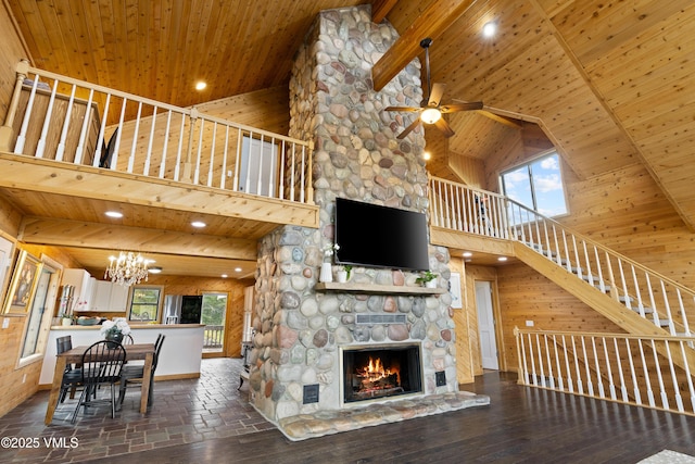 2980 Salt Creek Rd, Eagle, CO 81631 - living area with high vaulted ceiling, a wood ceiling with exposed beams, a chandelier, stairway, and a stone fireplace