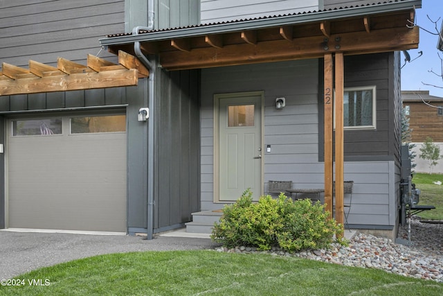 view of exterior entry with a garage