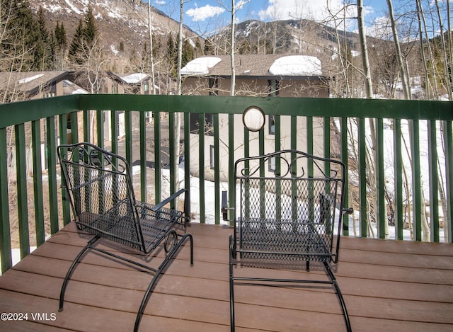 snow covered deck featuring a mountain view