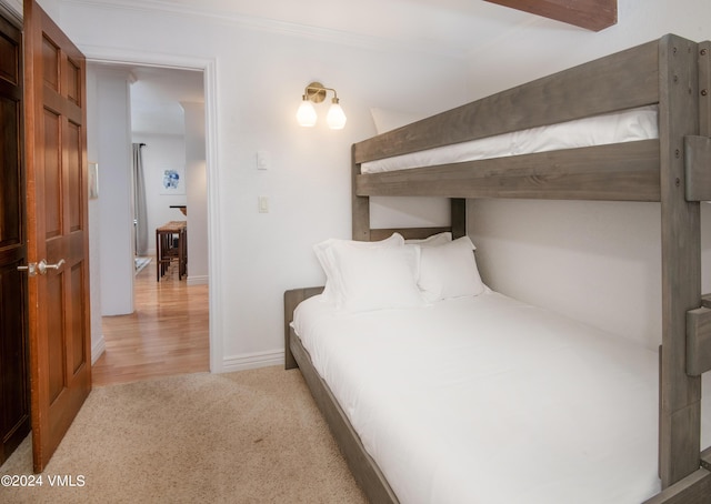 bedroom with light carpet and crown molding