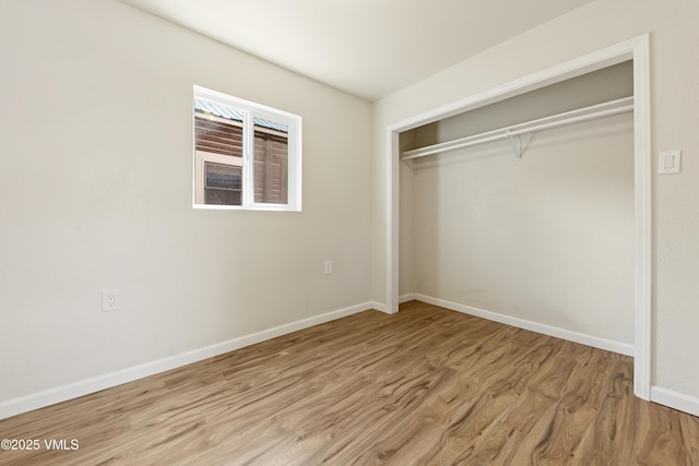 423 Second St, Gypsum, CO 81637 - unfurnished bedroom with a closet, wood finished floors, and baseboards