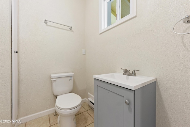 423 Second St, Gypsum, CO 81637 - bathroom featuring vanity, toilet, tile patterned flooring, baseboard heating, and baseboards