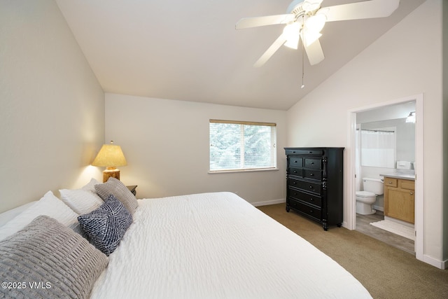 bedroom featuring carpet floors, a ceiling fan, baseboards, ensuite bathroom, and lofted ceiling