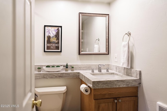 bathroom with toilet and vanity