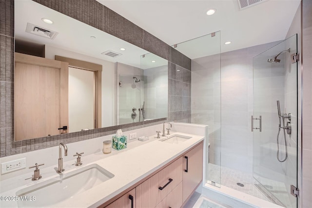 42 Riverfront Ln Unit 205, Avon, CO 81620 - full bathroom with a shower stall, double vanity, and recessed lighting