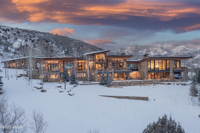 snow covered property featuring a mountain view