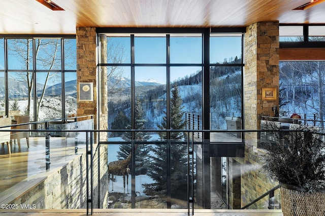 interior space with a mountain view and wooden ceiling