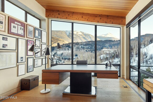 office area featuring wood ceiling, a mountain view, and hardwood / wood-style floors