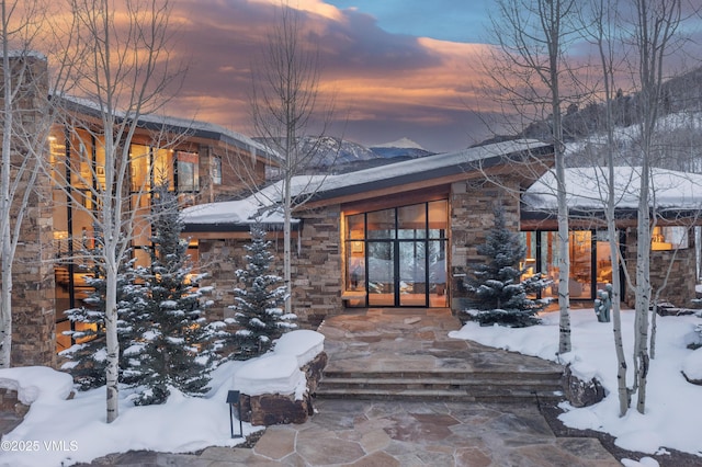 snow covered property entrance with a mountain view