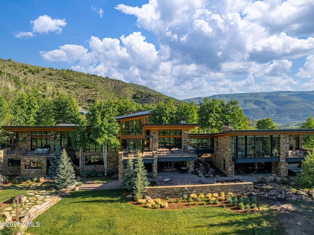34 Whiskey Rdg, Edwards, CO 81632 - view of grassy yard featuring a sunroom and a deck with mountain view
