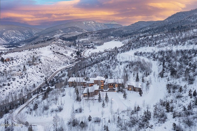 snowy aerial view with a mountain view