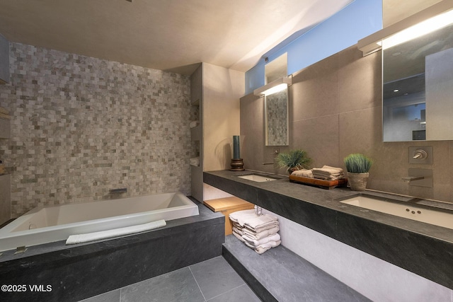 bathroom featuring vanity, tile walls, tile patterned floors, and tiled bath