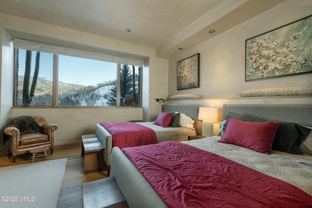 bedroom with a mountain view and hardwood / wood-style floors