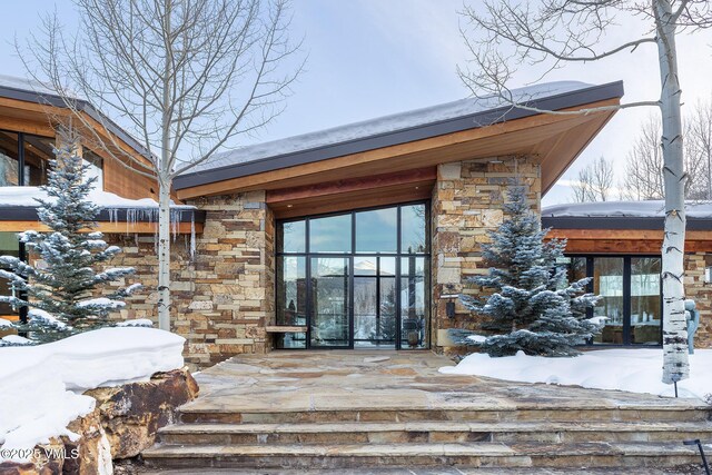 view of snow covered property entrance