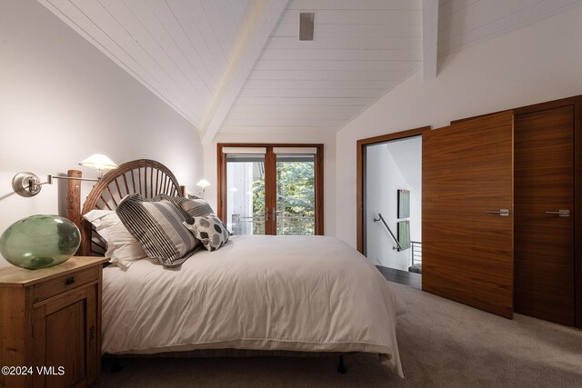 carpeted bedroom with vaulted ceiling with beams