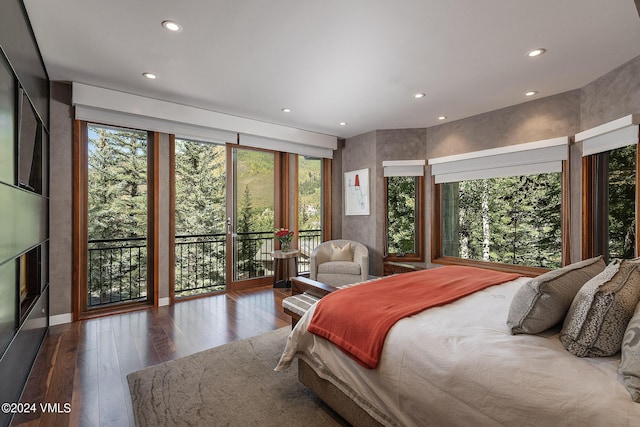 bedroom featuring access to outside, hardwood / wood-style floors, and recessed lighting