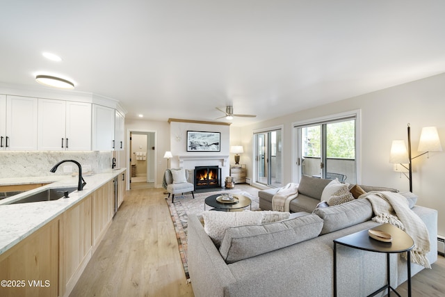 180 Offerson Rd Unit 2, Beaver Creek, CO 81620 - living area with ceiling fan, a warm lit fireplace, light wood finished floors, baseboards, and recessed lighting