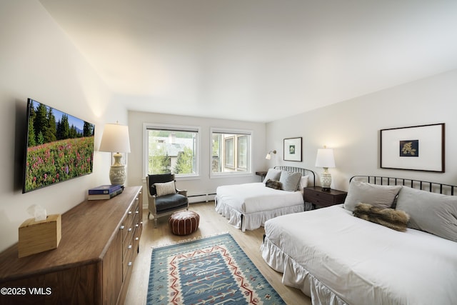 180 Offerson Rd Unit 2, Beaver Creek, CO 81620 - bedroom featuring a baseboard radiator and light wood-style floors