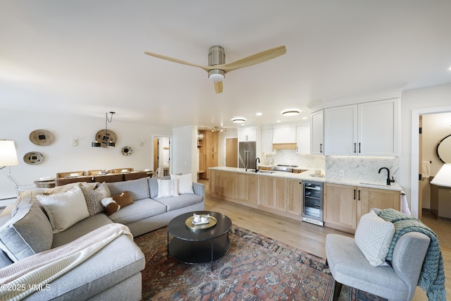 180 Offerson Rd Unit 2, Beaver Creek, CO 81620 - living room featuring wine cooler, light wood-style floors, and ceiling fan