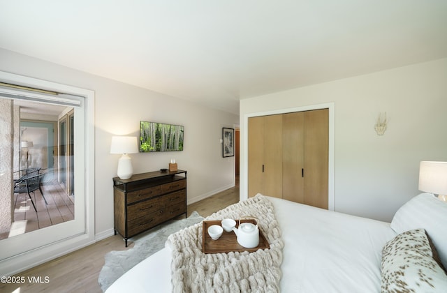 180 Offerson Rd Unit 2, Beaver Creek, CO 81620 - bedroom with wood finished floors, a closet, and access to exterior