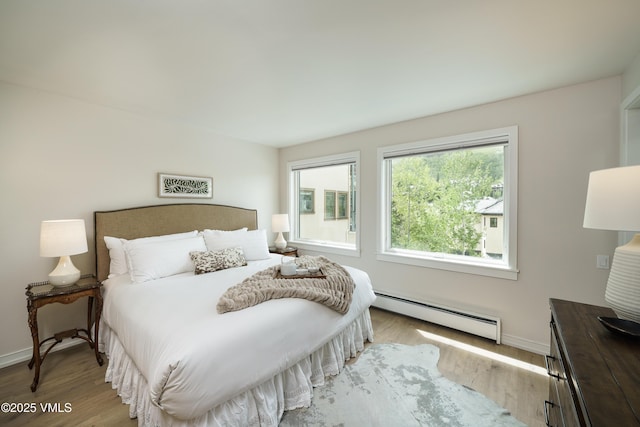 180 Offerson Rd Unit 2, Beaver Creek, CO 81620 - bedroom with a baseboard heating unit, baseboards, and wood finished floors