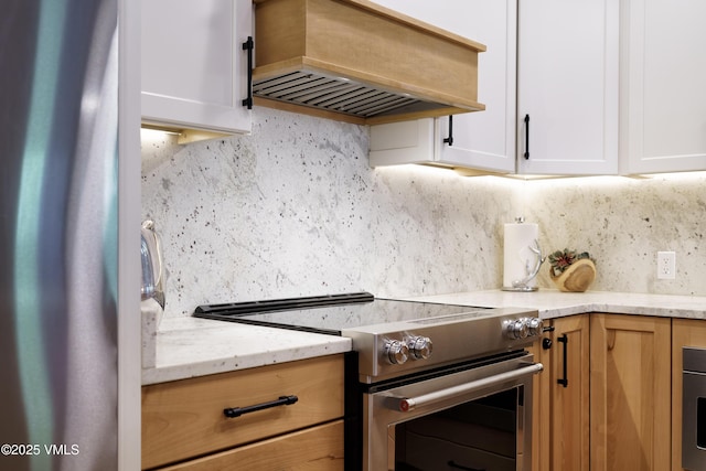 180 Offerson Rd Unit 2, Beaver Creek, CO 81620 - kitchen with stainless steel appliances, custom exhaust hood, decorative backsplash, white cabinets, and light stone counters