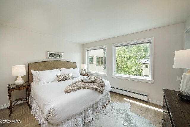 180 Offerson Rd Unit 2, Beaver Creek, CO 81620 - bedroom with a baseboard heating unit and wood finished floors