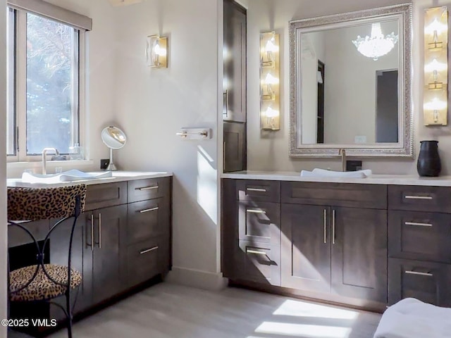 bathroom featuring vanity, a wealth of natural light, and baseboards