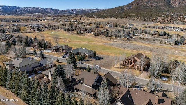 drone / aerial view featuring a residential view and a mountain view