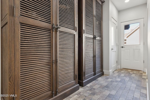 interior space featuring brick floor and recessed lighting