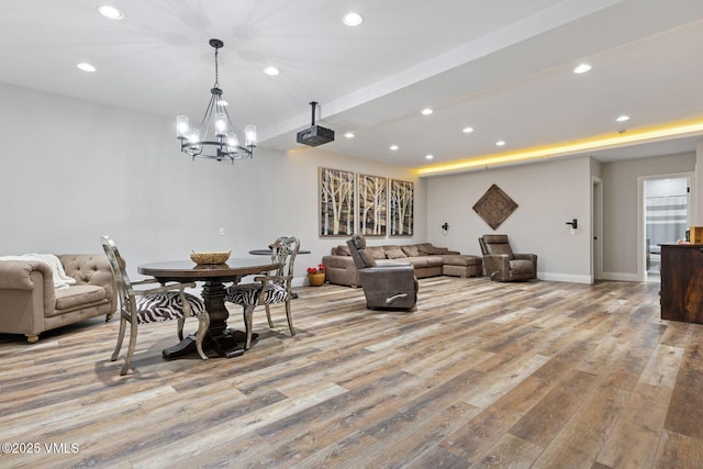 living room featuring baseboards, recessed lighting, and light wood-style floors