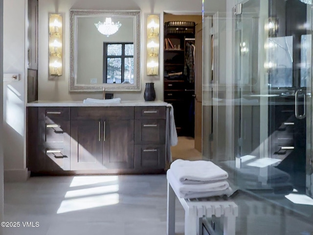 full bathroom with vanity and a shower stall