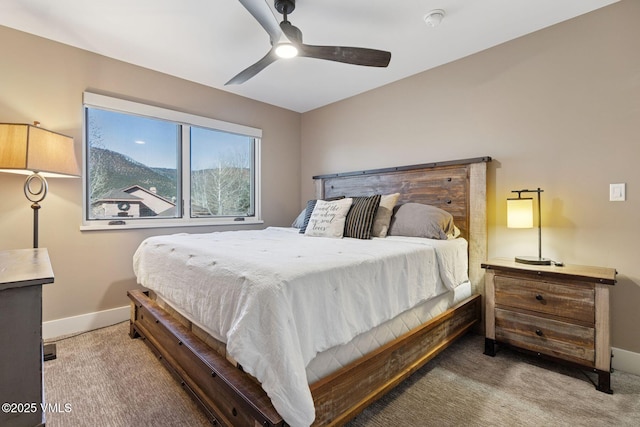 carpeted bedroom featuring a ceiling fan and baseboards