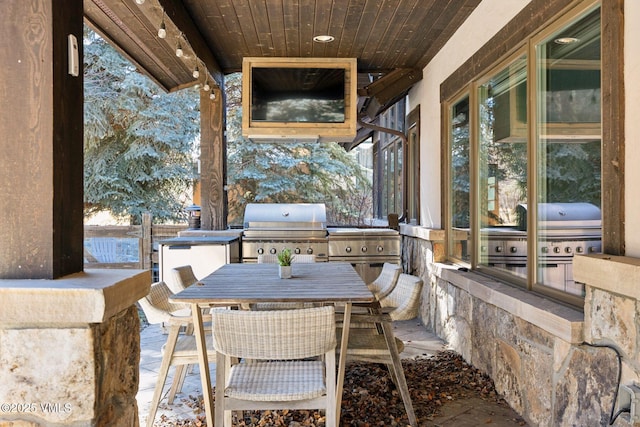 view of patio / terrace with outdoor dining area, exterior kitchen, and area for grilling