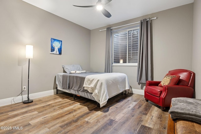 bedroom with wood finished floors, a ceiling fan, and baseboards