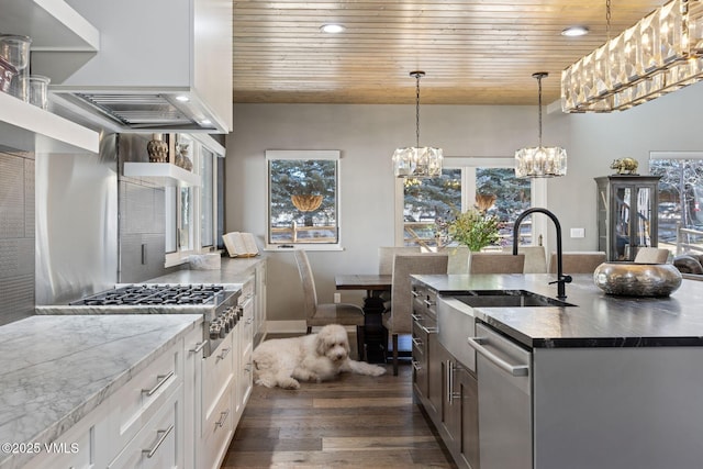 kitchen with appliances with stainless steel finishes, wood ceiling, dark wood-style flooring, and a sink